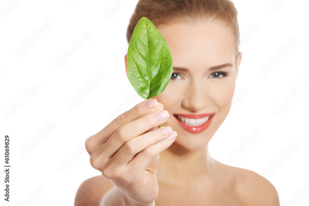 Beautiful caucasian topless woman with one green leaf. Beautiful caucasian topless woman with one green leaf.