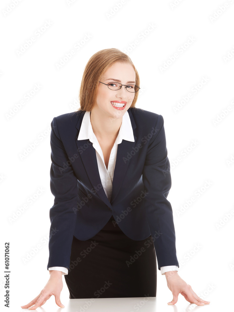 Young attractive business woman bending over table. Young attractive business woman bending over table.