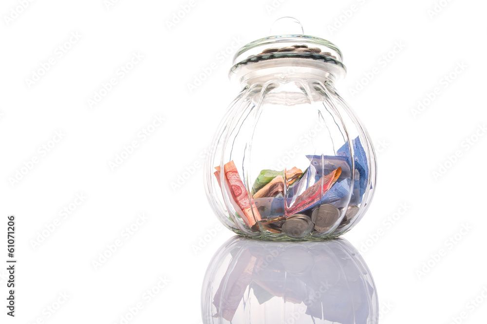 Coins and paper money in a cookie jar Coins and paper money in a cookie jar
