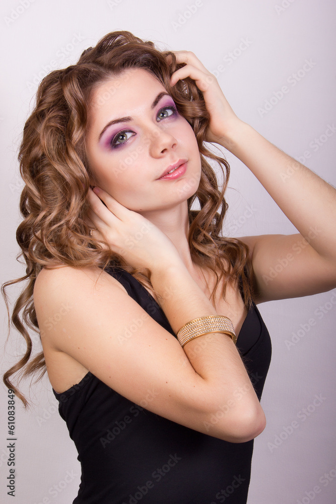 Portrait of a beautiful young girl with brown curly hair Portrait of a beautiful young girl with brown curly hair