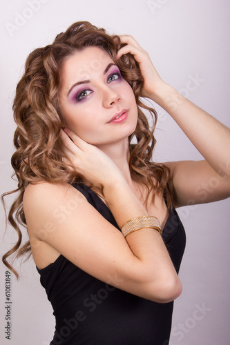 Portrait of a beautiful young girl with brown curly hair