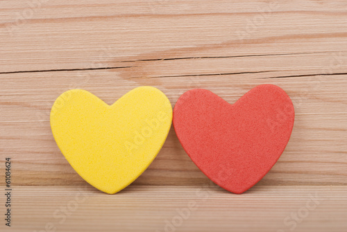 Two hearts on a wooden background.
