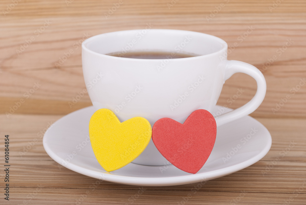 Coffee cup and hearts on a wooden background. Coffee cup and hearts on a wooden background.