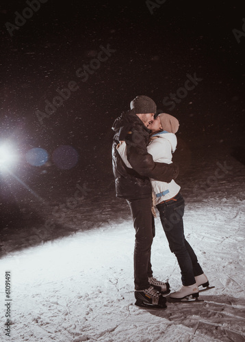 young couple in winter skate rink