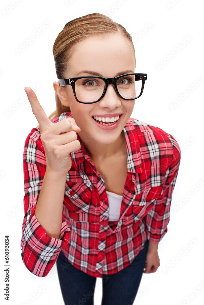 smiling teenager in eyeglasses with finger up smiling teenager in eyeglasses with finger up