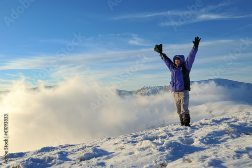 Photographer in winter mountain