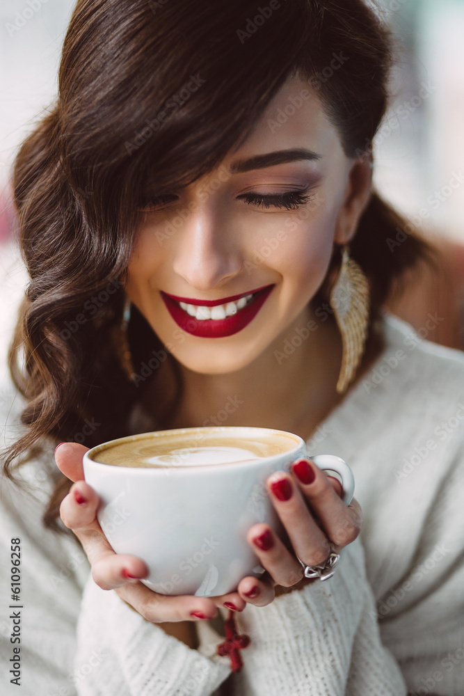 Young girl drinking coffee in a trendy cafe Young girl drinking coffee in a trendy cafe