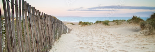 Fototapeta Panorama landscape of sand dunes system on beach at sunrise