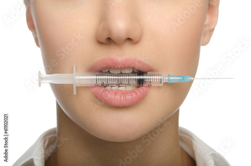 Girl biting a syringe