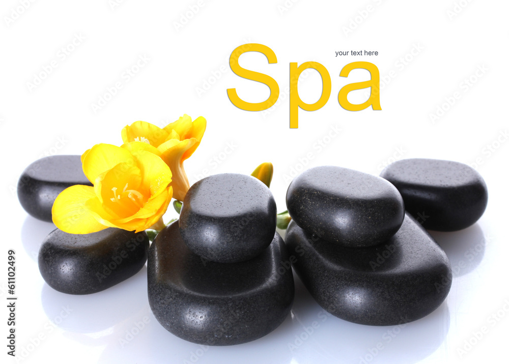 Spa stones and yellow flower isolated on white Spa stones and yellow flower isolated on white