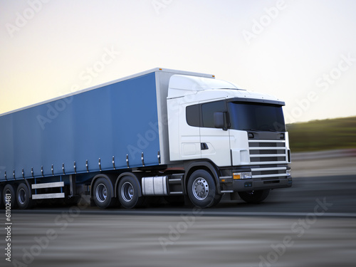 Cargo truck traveling down the road with motion blur