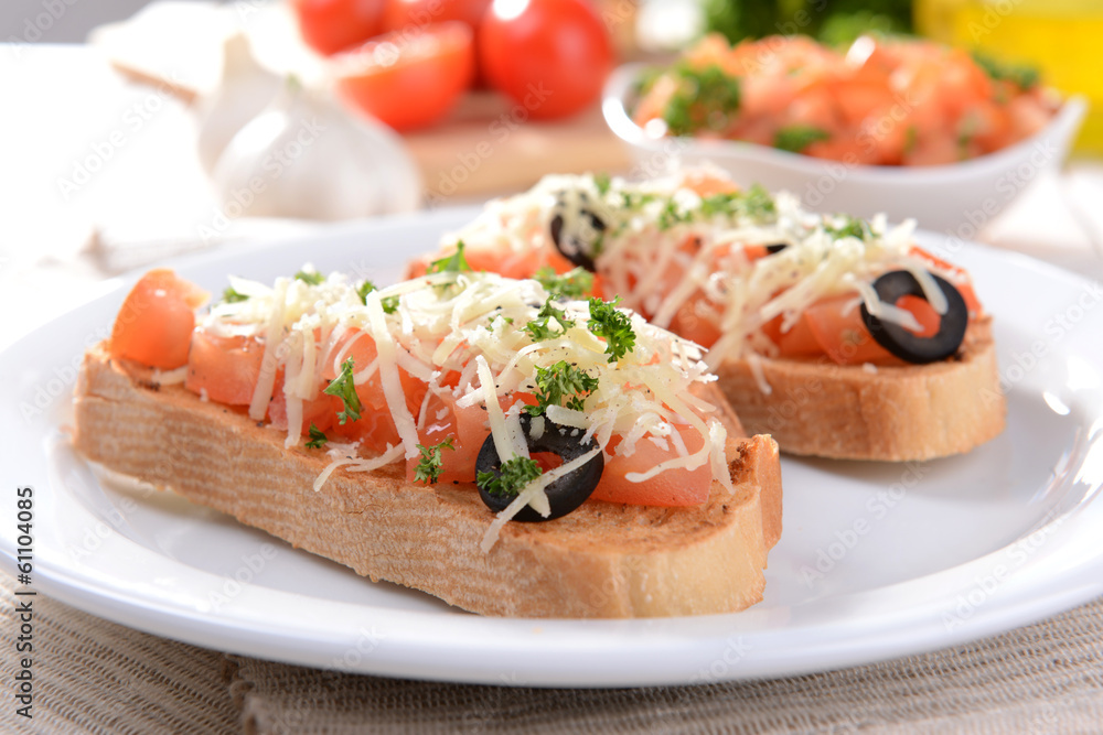 Delicious bruschetta with tomatoes on plate on table close-up Delicious bruschetta with tomatoes on plate on table close-up