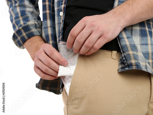 Man with packet of cocaine, close up, isolated