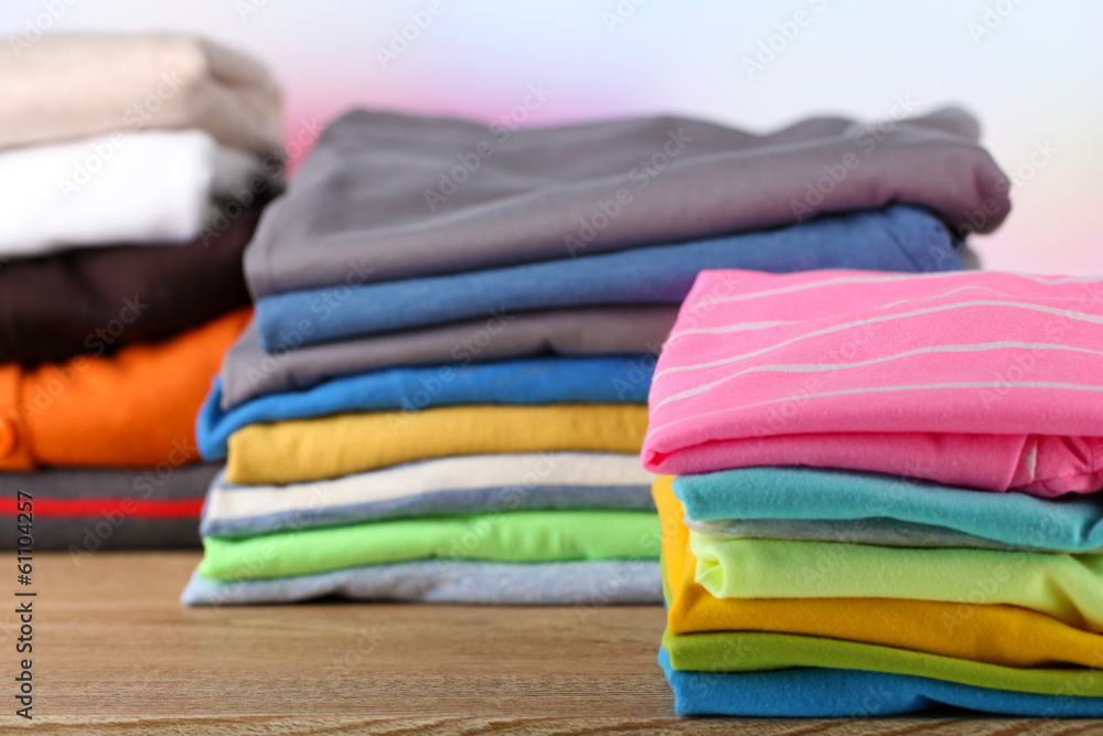Stack of colorful clothes, on light background Stack of colorful clothes, on light background