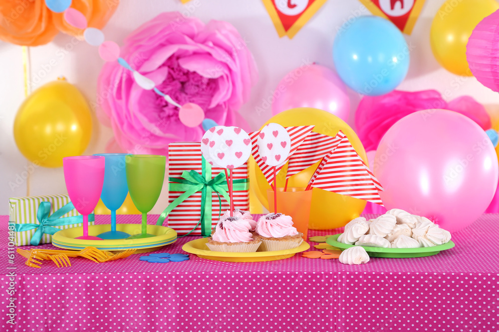 Festive table setting for birthday on celebratory decorations