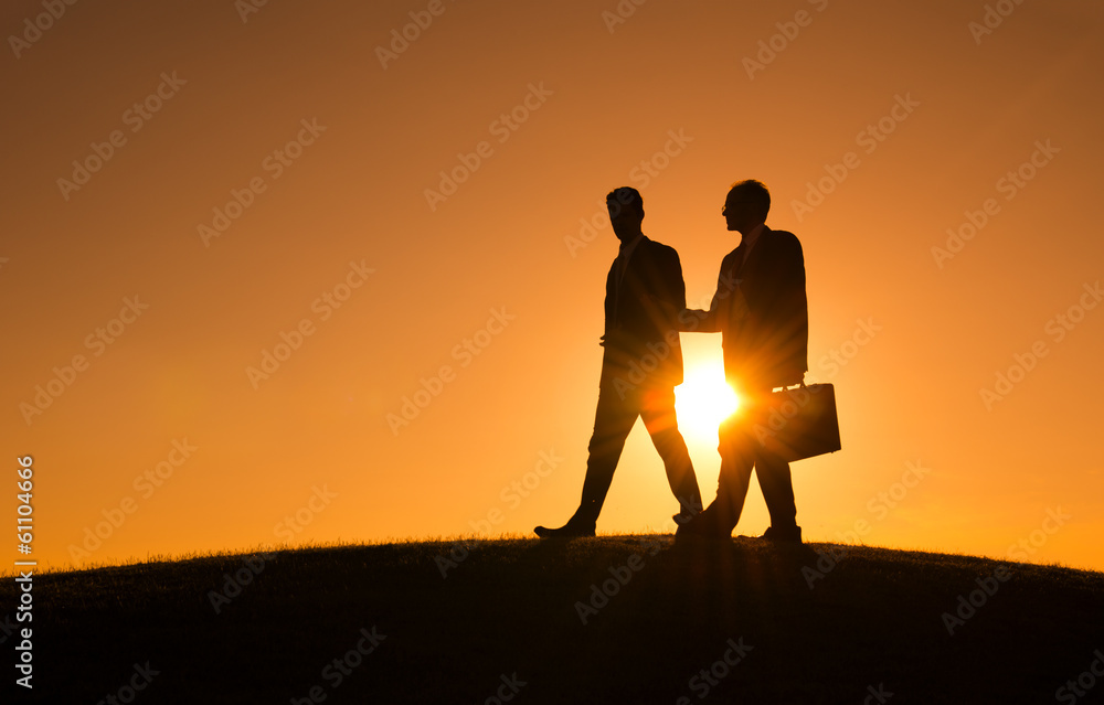 Silhouette of Two Businessmen Walking at Sunset