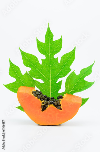 Papaya piece and seed with its green leaf