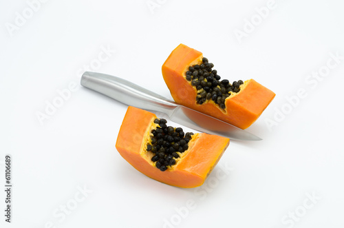 Two piece of papaya is divided by a knife
