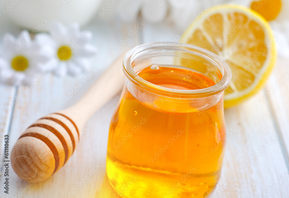 fresh honey in the glass bank and camomiles fresh honey in the glass bank and camomiles