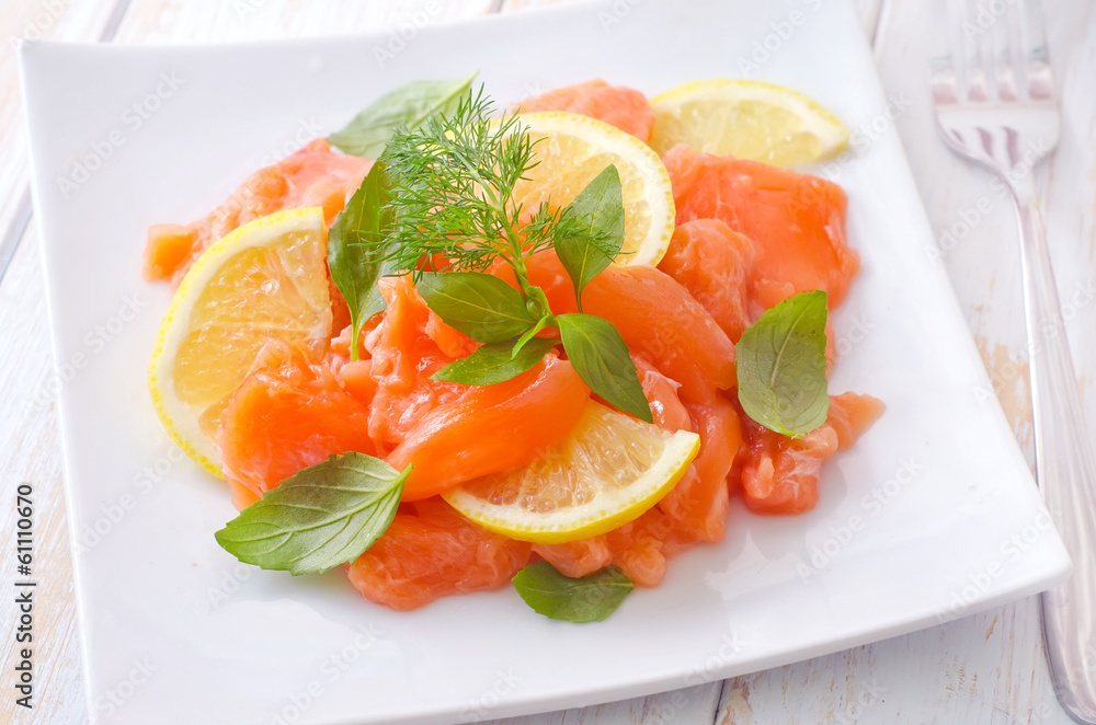 fresh salmon with lemon on the white plate