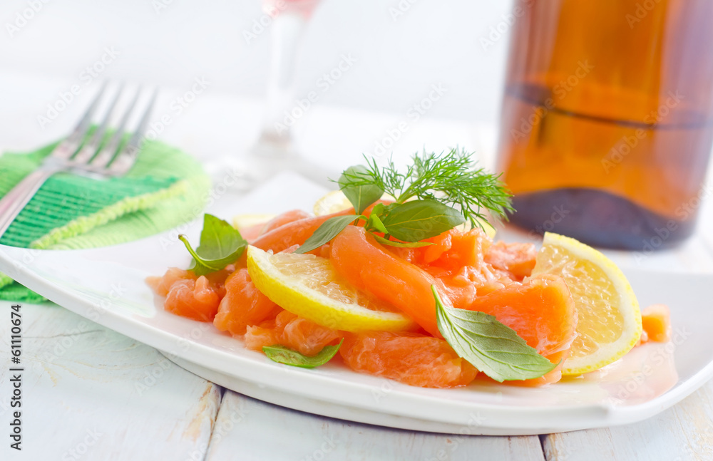 fresh salmon with lemon on the white plate fresh salmon with lemon on the white plate