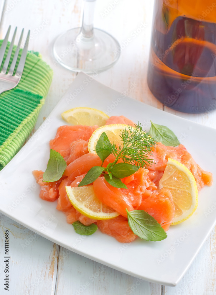 fresh salmon with lemon on the white plate fresh salmon with lemon on the white plate