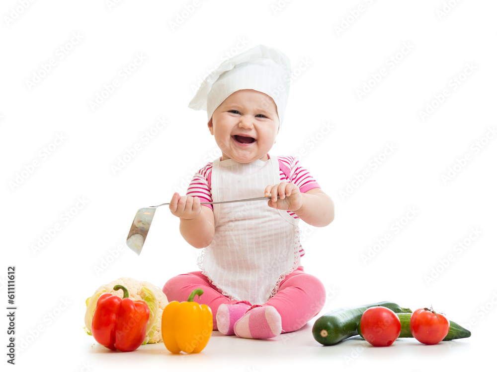 Kid in chef hat with healthy food vegetables