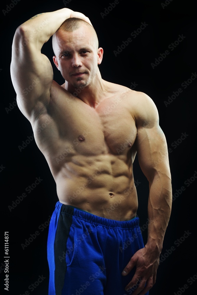 Fototapeta premium Body builder champion posing in studio