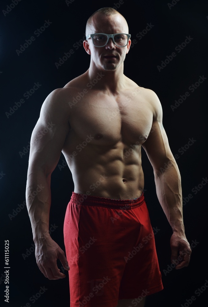 Fototapeta premium Body builder champion posing in studio