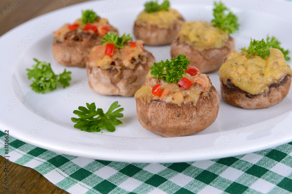 Stuffed mushrooms on plate on table close-up