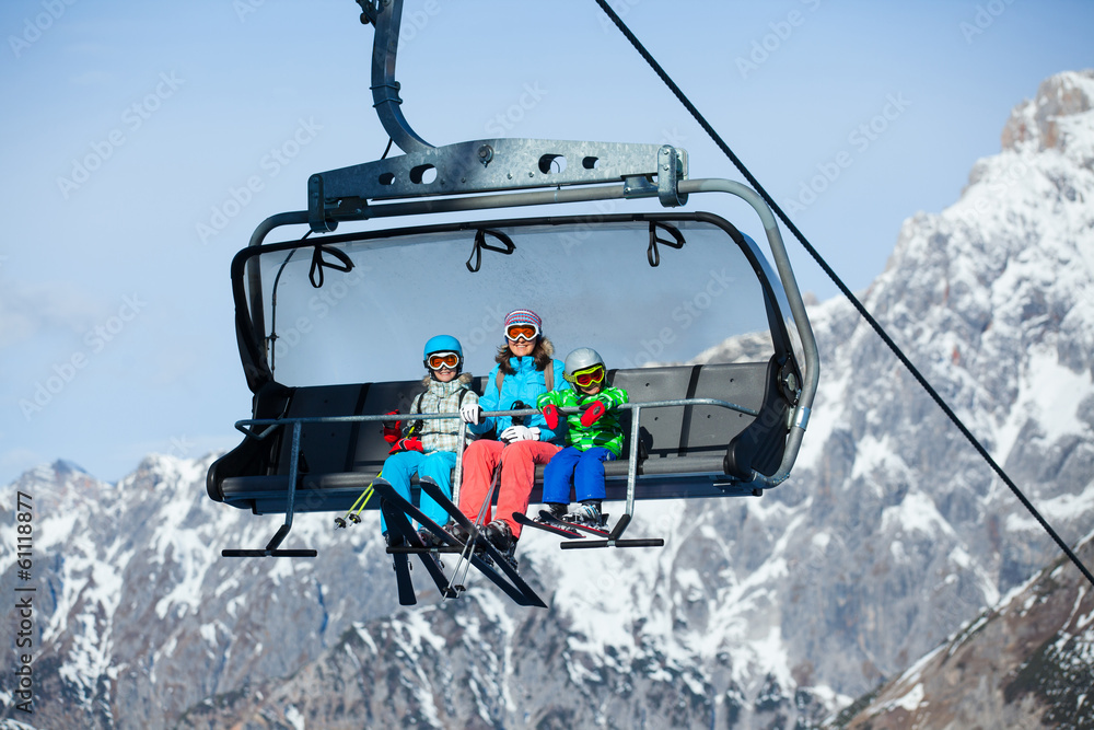 Skiers on a ski lift.