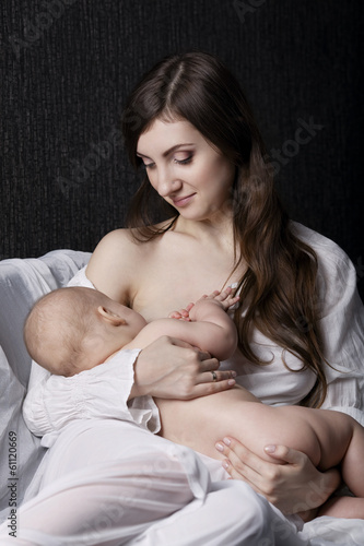 Mother breast feeding her infant studio shot