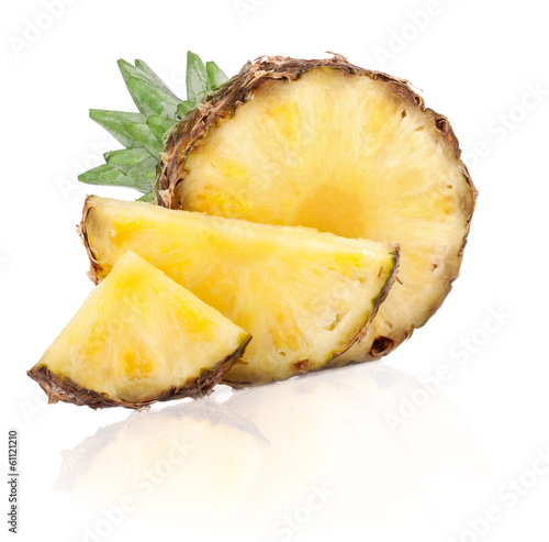 Ripe pineapple fruits with slices and green leaves isolated on w