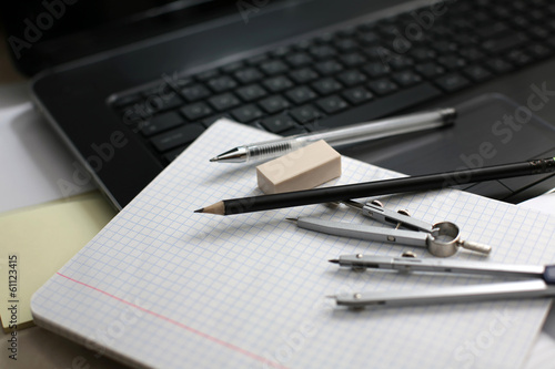 Laptop and compass on a notebook