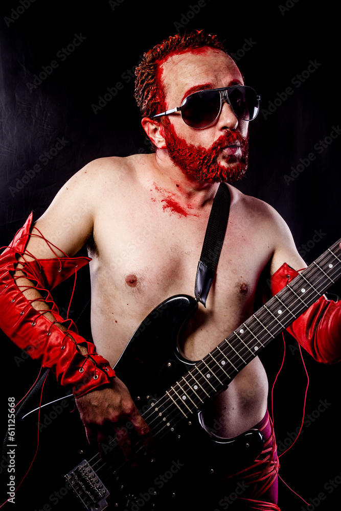 Fototapeta premium Fun, guitarist with electric guitar black, wearing face paint an
