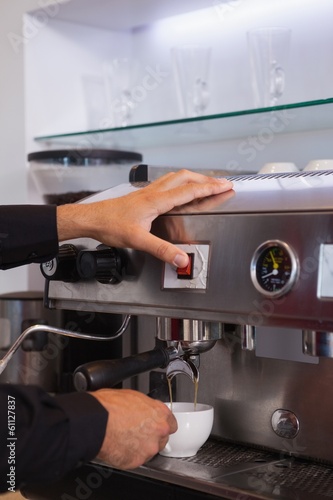 Barista making cup of hot coffee