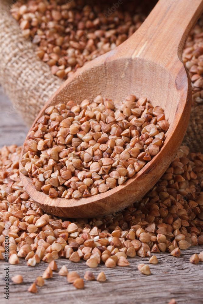 Fototapeta premium buckwheat groats macro in a bag with a wooden spoon