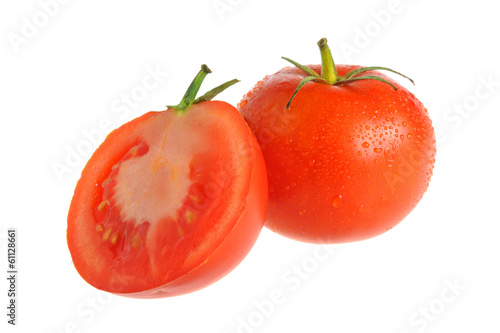 A half and a whole tomatoes covered by water drops isolated on w