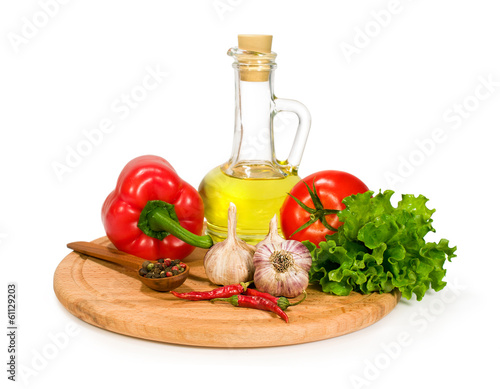 fresh vegetables , spices and olive oil in a bottle