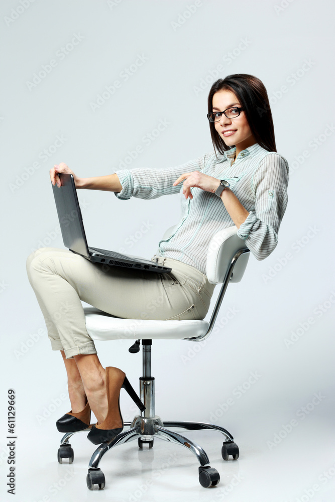 businesswoman sitting on the office chair with laptop businesswoman sitting on the office chair with laptop