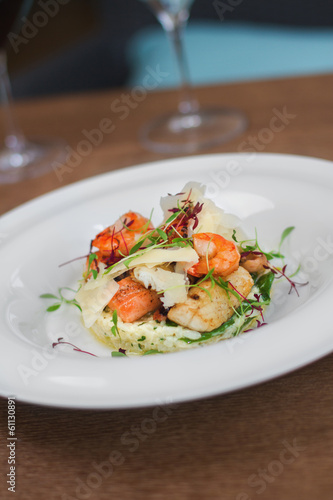 Image of tasty salad with shrimps and cheese in restaurant