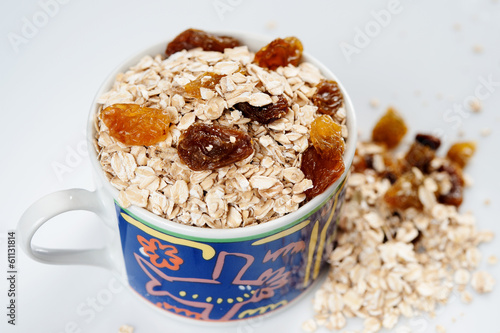 Oatmeal with raisins isolated on a light background