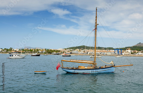 Old sailboat in tropical marina bay