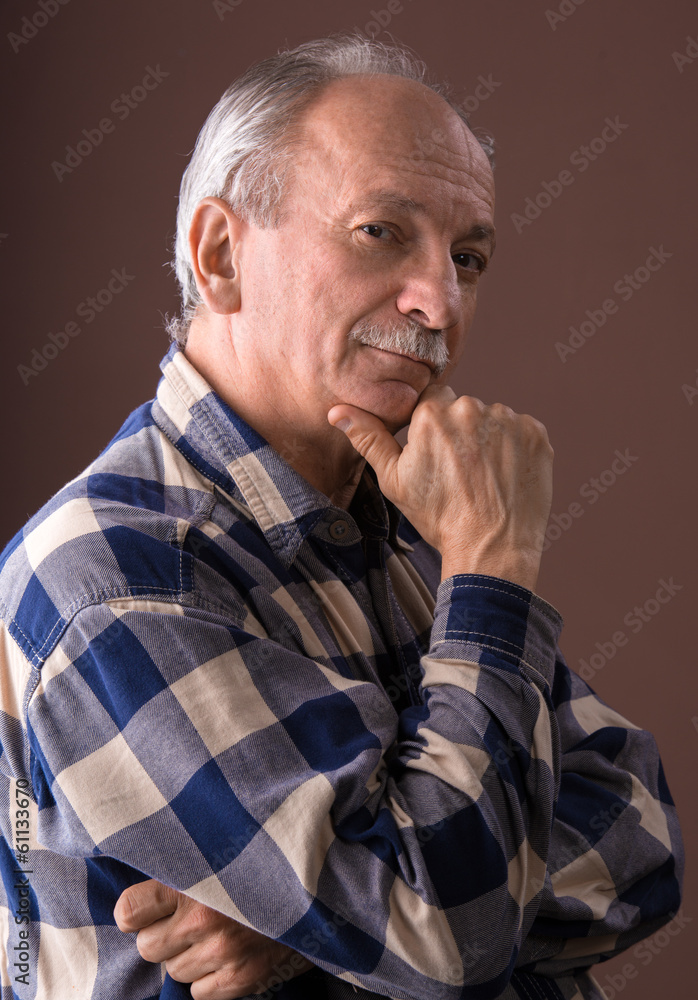 Portrait of a smiling elderly man on a brown background Portrait of a smiling elderly man on a brown background