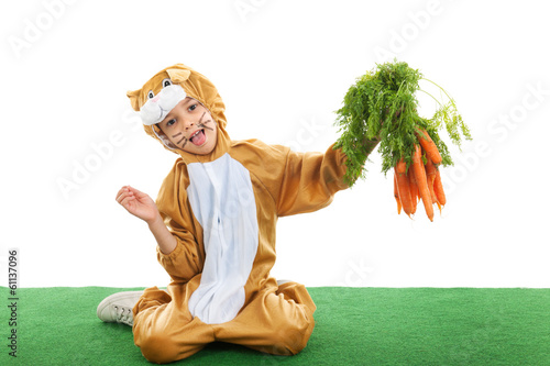 Child as easter hare with carrots photo