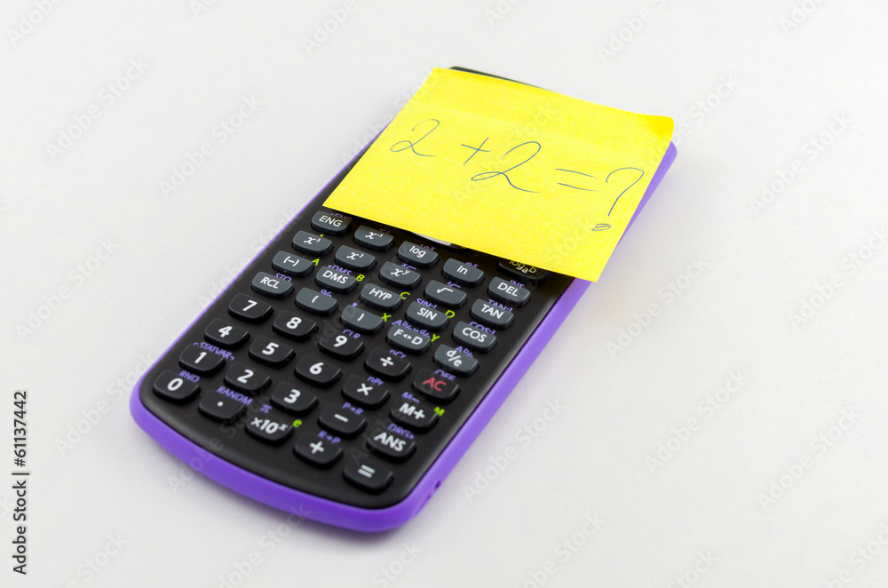 Calculator and yellow sticky note on the calculator Calculator and yellow sticky note on the calculator
