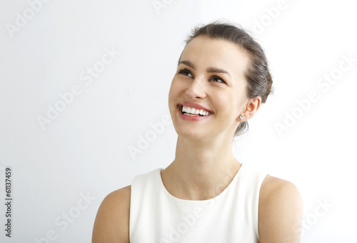 Young woman smiling against white background