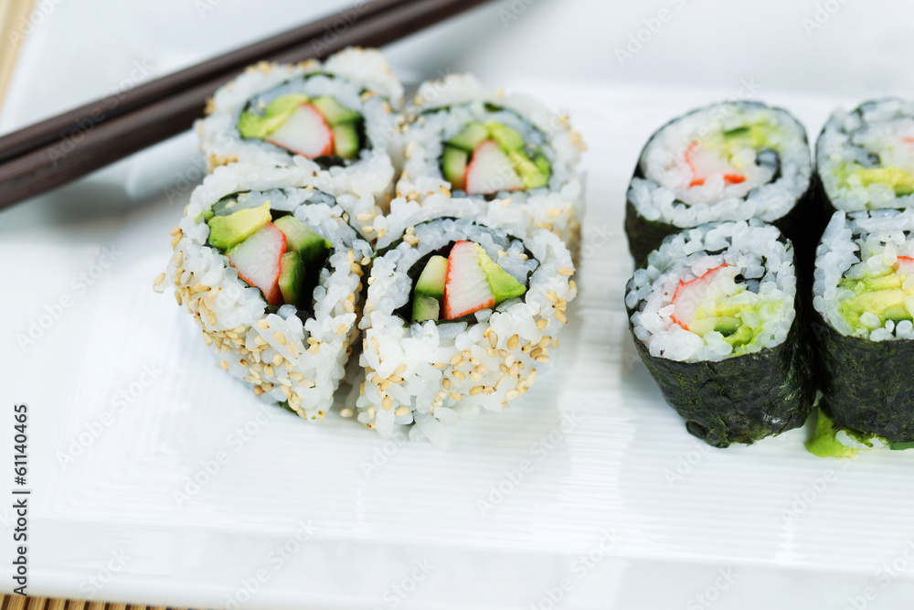 Top view shot of California Rolls in white plate Top view shot of California Rolls in white plate