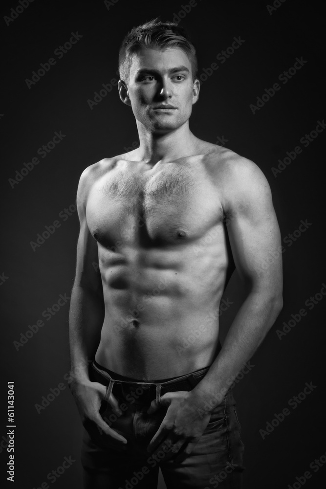 Strong athletic man on dark background Strong athletic man on dark background