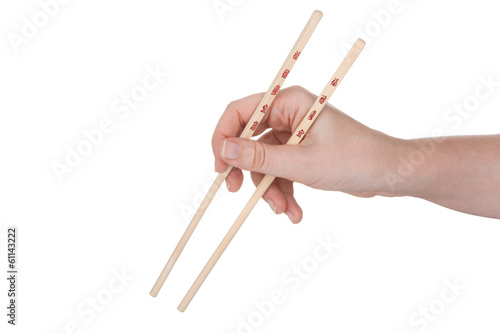 Female hand holding crossed chopsticks with chinese inscription